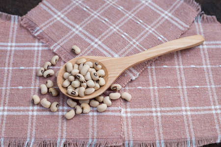 Soy bean pulses in a wooden spoon. Selective focusの写真素材