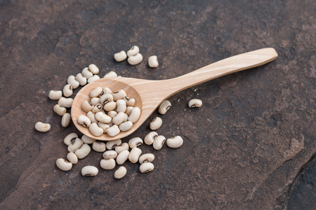 Soy bean pulses in a wooden spoon. Selective focusの写真素材