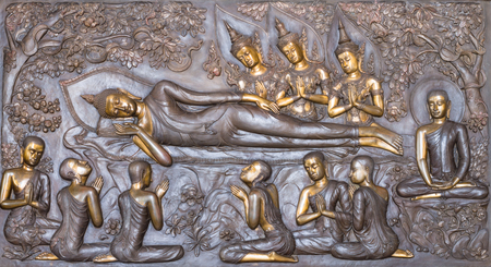Bronze bas reliefs buddhism in wat pa phu kon in thailandの写真素材