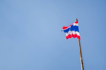 Thai flag in front of blue sky in sunny dayの写真素材