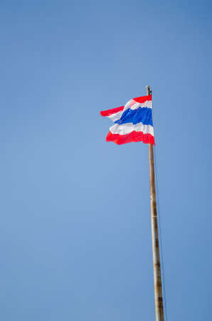 Thai flag in front of blue sky in sunny dayの写真素材