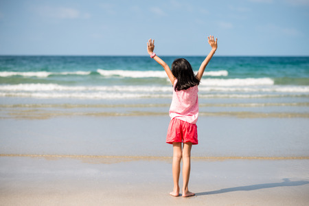 Happy little girl  on the beach. Girl at vacations on seaの写真素材