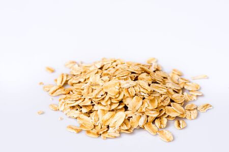 Rolled oats (oat flakes) on white background. Close-up.の写真素材