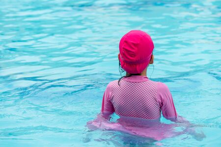 little asian girl in swimming poolの写真素材