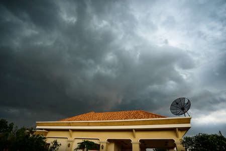 heavy strom clouds raining incoming over  the roof