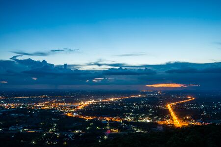 Aerial view of town at night from the top of a mountainの写真素材