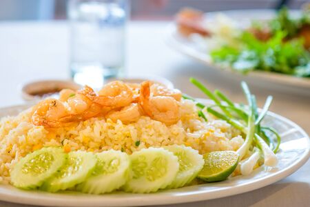 Thai Fried rice with shrimp, white onions, green onions and cucumber with lime on the side