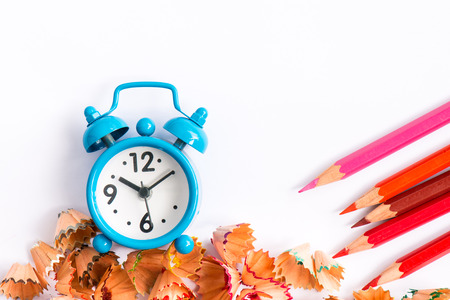 Alarm clock with color pencil and shaving on white backgroundの写真素材