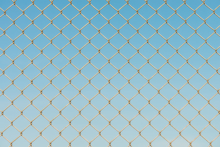 Close-up of metal wire fence on a blue sky background