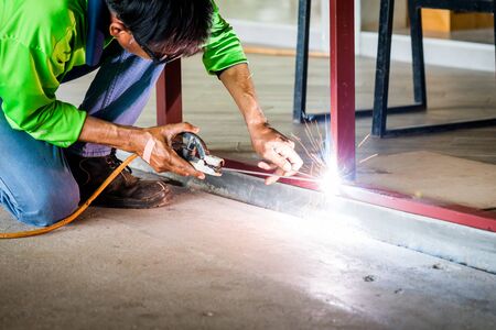 Worker welding a structure frame