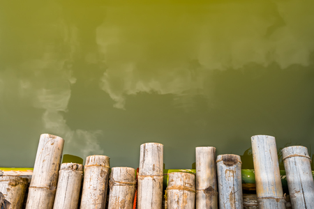 Bamboo raft heading on lake with water backgroundの写真素材