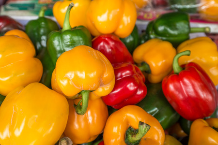 red yellow and green bell pepper in basketの写真素材