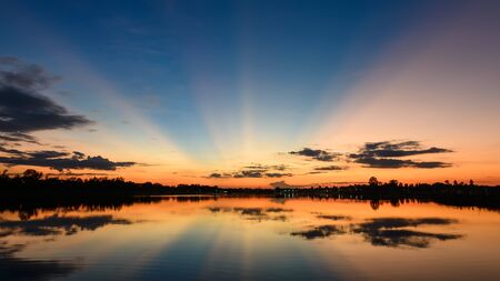 colorful sky at sunset on the lake, blue time with light shiningの写真素材