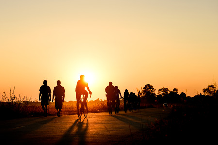 Silhouette of cyclist in motion on the background of beautiful sunset