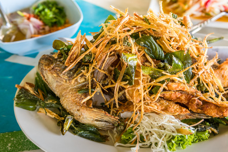 Fish fry on white plate with vegetable, thai foodの写真素材