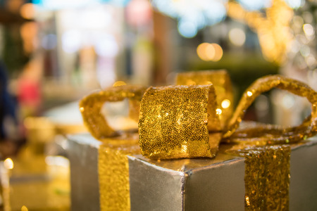 Christmas gifts boxes and ornaments on Christmas tree with light bokeh