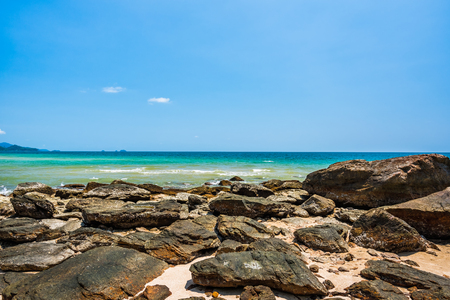 Sea rocks on the beach in sunny day with blue sky background, Beautiful summer landscapeの写真素材
