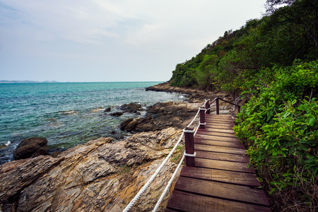 Wood bridge in to the sea and sea rocks, sidewalk on the beach at Khao Laem Ya Moo Koh Samed National Park, Rayong, Thailand.の写真素材