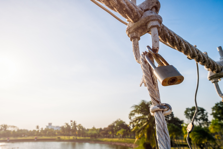 The wire metal rope bridge on blue sky backgroundの写真素材