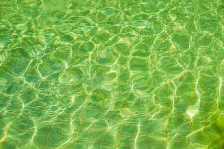 Green abstract background from wave with tile in swimming poolの写真素材