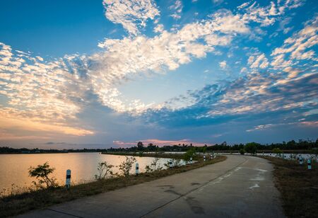 Colorful sky on sunset at the lake in the park landscapeの写真素材