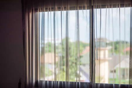 White curtain on window with bright light from outside