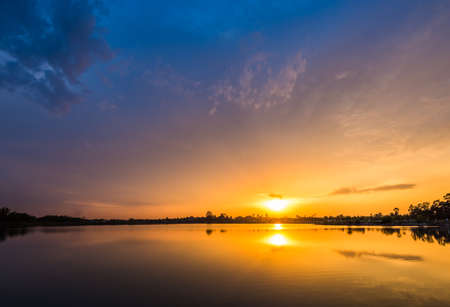 Colorful sky on sunset at the lake in the park landscapeの写真素材