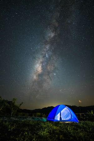 Landscape of Milky Way galaxy with Tent camp, Night sky with stars and silhouette of Tent camp