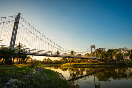 The metal rope bridge in the park, Suspension bridge on sunsetの写真素材