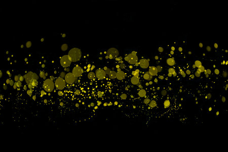 Yellow light bokeh of Firefly lightning bug on black background for graphic design