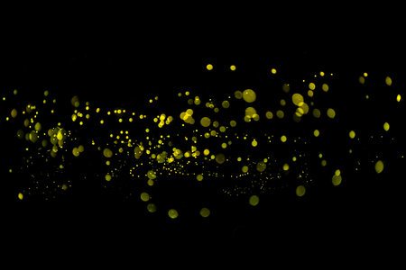 Yellow light bokeh of Firefly lightning bug on black background for graphic designの写真素材
