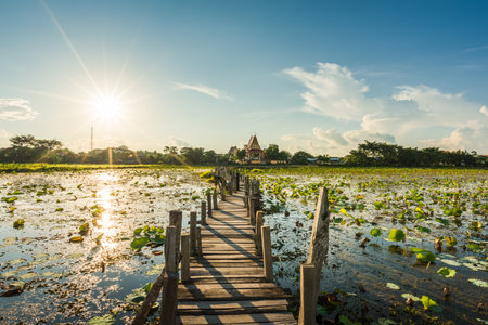 Long wooden bridge across the lake on sunset background at Kae Dam District, Maha Sarakham Province, Thailandの写真素材