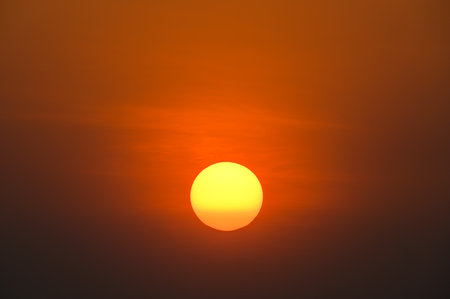 Colorful cloud and sky with big orange sun on sunset use for backgroundの写真素材