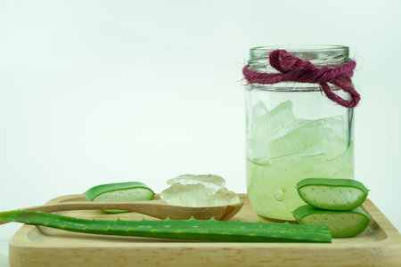 sliced and leaf of fresh aloe vera with aloe vera gel in glass on white backgroundの写真素材