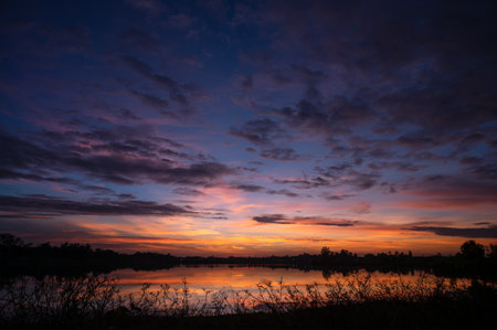 Colorful cloud and sky on sunset with lake landscapeの写真素材