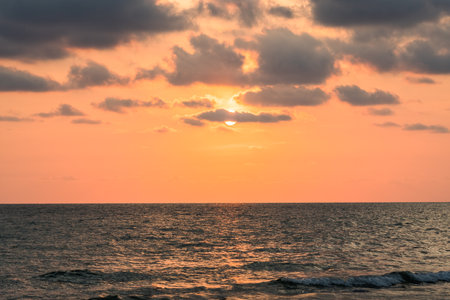 beautiful sunset on the beach. Sun, sky, sea, waves and sand. A holiday by the seaの写真素材