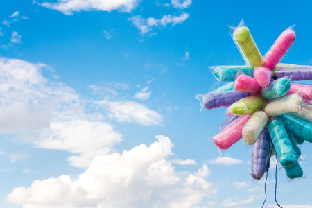Cotton candy in a plastic bag with a sky backgroundの写真素材