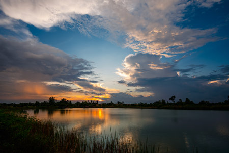 Beautiful sky at sunset at the lake in the park backgroundの写真素材