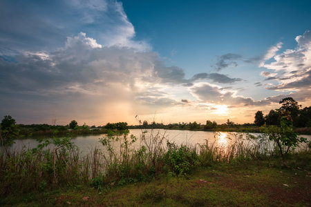 Beautiful sky at sunset at the lake in the park backgroundの写真素材