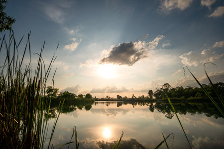Beautiful sky at sunset at the lake in the park backgroundの写真素材