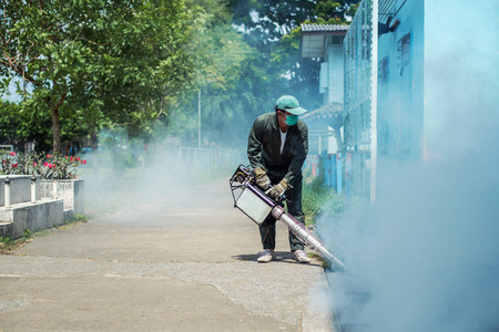 Man work fogging to eliminate mosquito for preventing spread dengue fever and zika virus