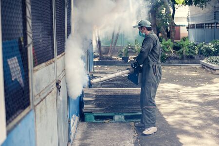 Man work fogging to eliminate mosquito for preventing spread dengue fever and zika virus