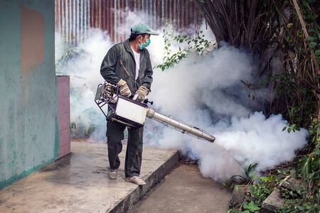 Man work fogging to eliminate mosquito for preventing spread dengue fever and zika virusの写真素材