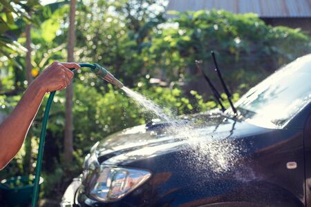 Soft focus hand holding car wash hoseの写真素材