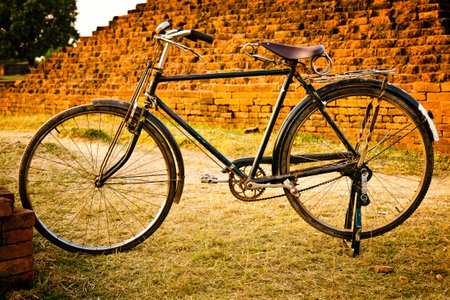 Old bicyacle and old wall at Nalanda Monastery in India の写真素材