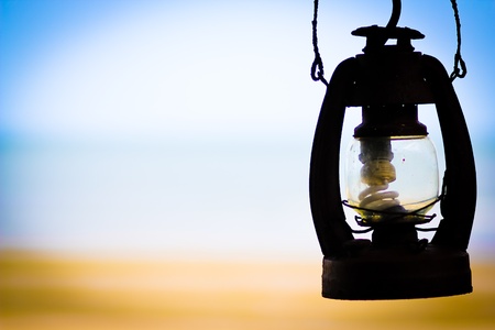 a picture of an oil lamp  Beach  on the background の写真素材