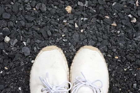 Shoes, white shoes standing on rocks top view.の写真素材