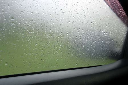 Blurred rain drop on the car glass background, water drops at the car