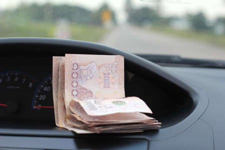Money in the car on the background of the console in the car