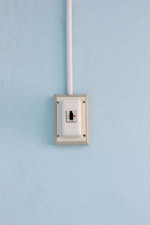 Central air-conditioning temperature control panel on a blue wall